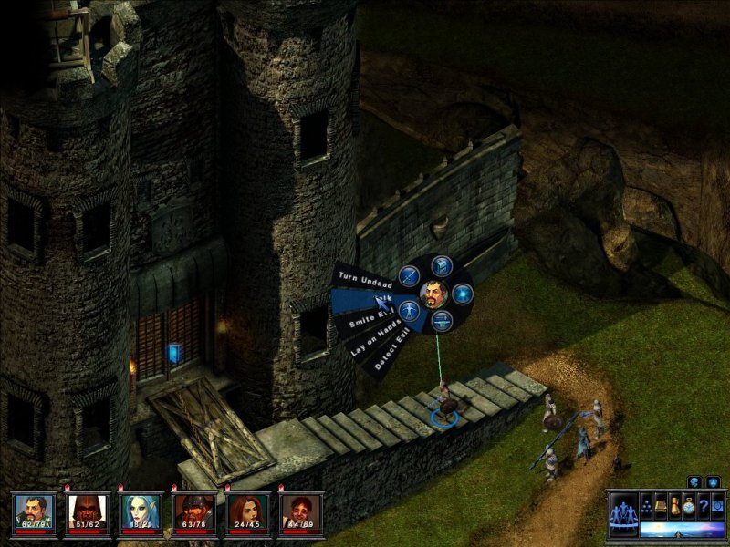 A stone castle. Five people wearing armour and carrying weapons are climbing the stairs.